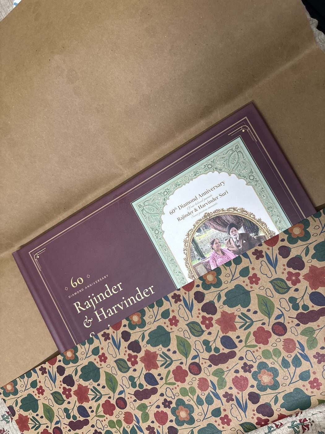 The same album beside the floral paper it was wrapped in
