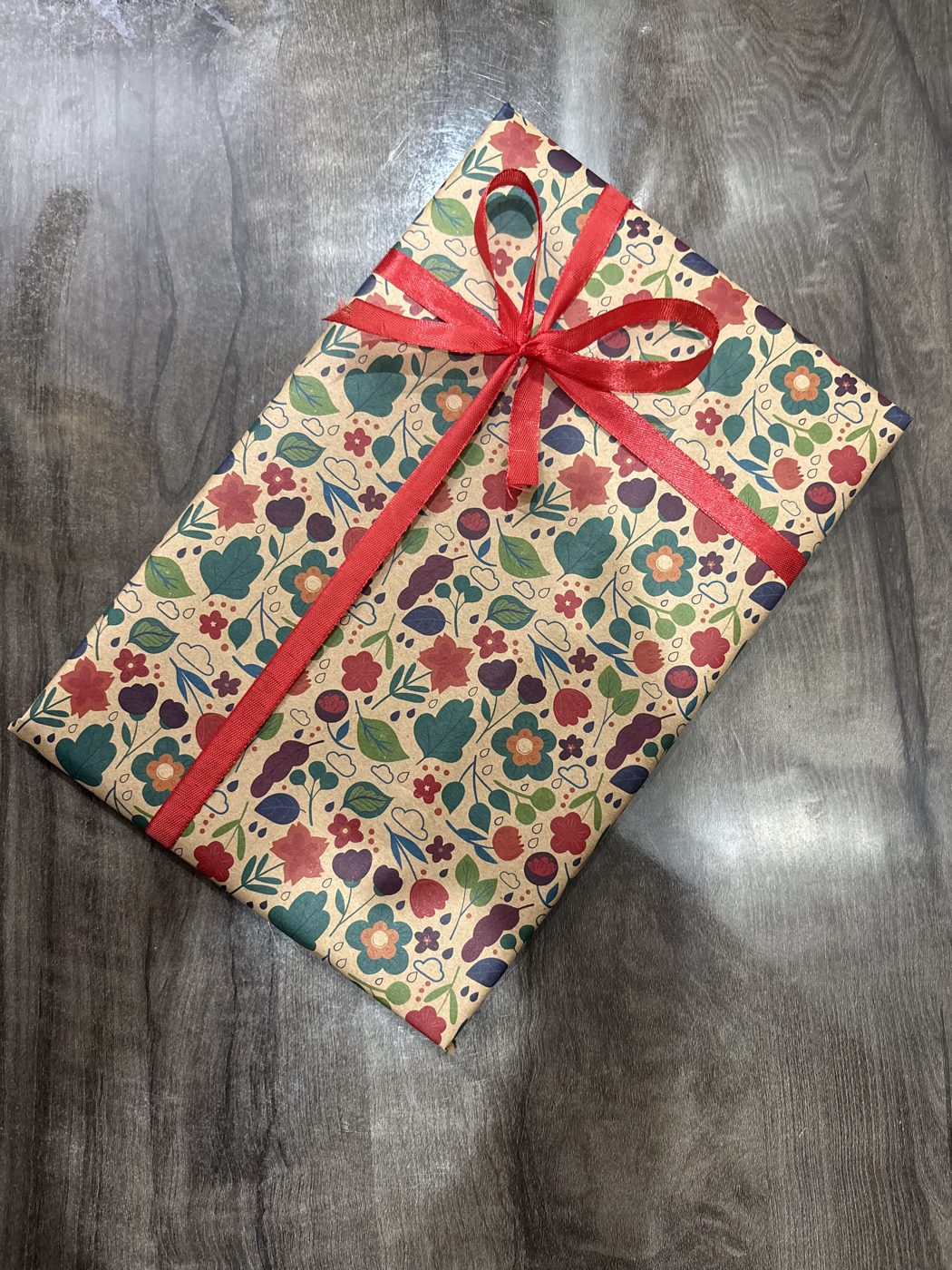 The album wrapped in floral paper with a red ribbon, before posting