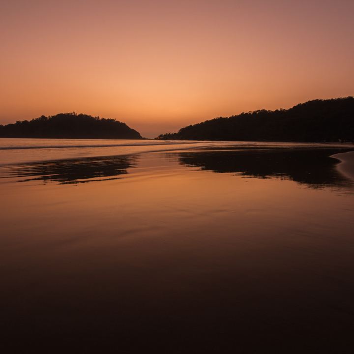 Sunset over the sea at Palolem beach, Goa